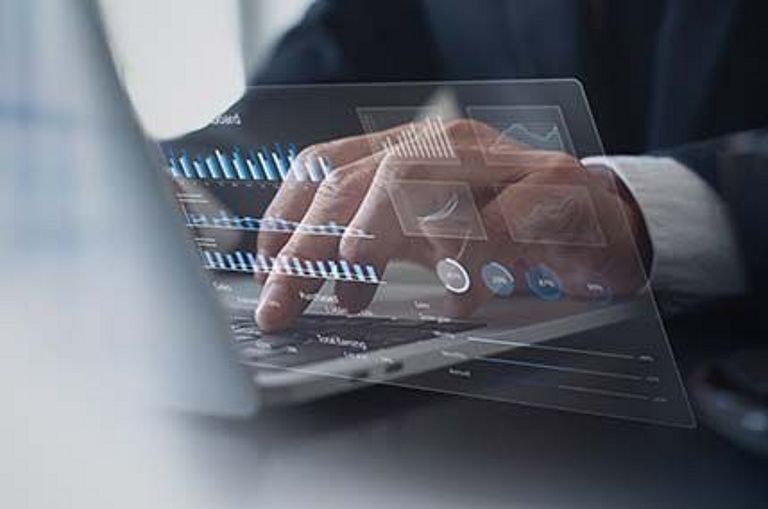 Digital Financial Report Symbol: Business person studying a financial report on a laptop computer