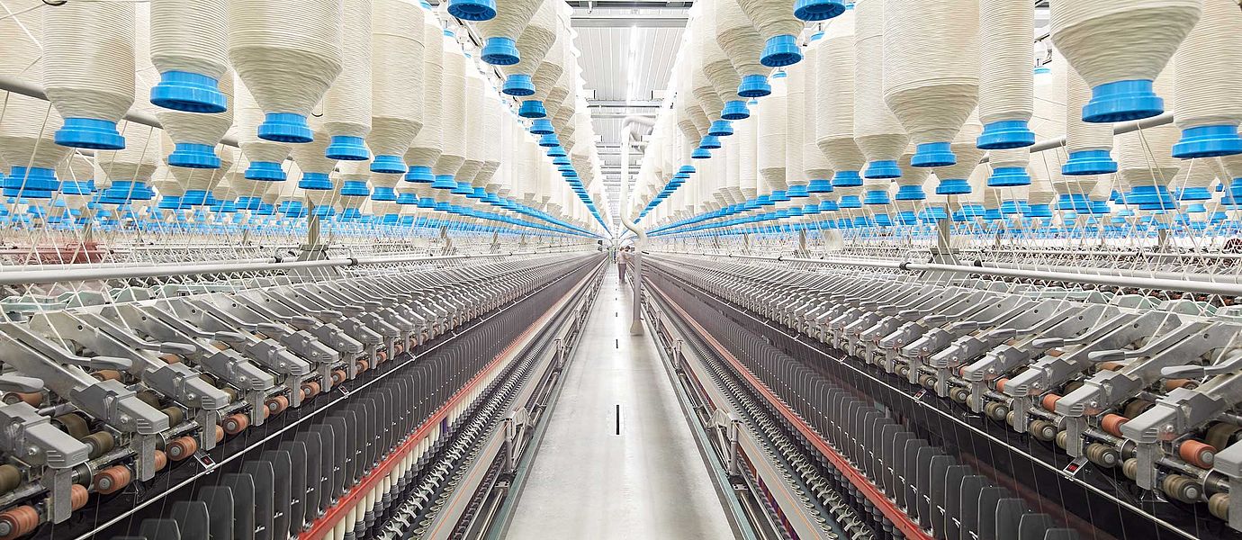 Two compact-spinning machines side by side in a spinning mill