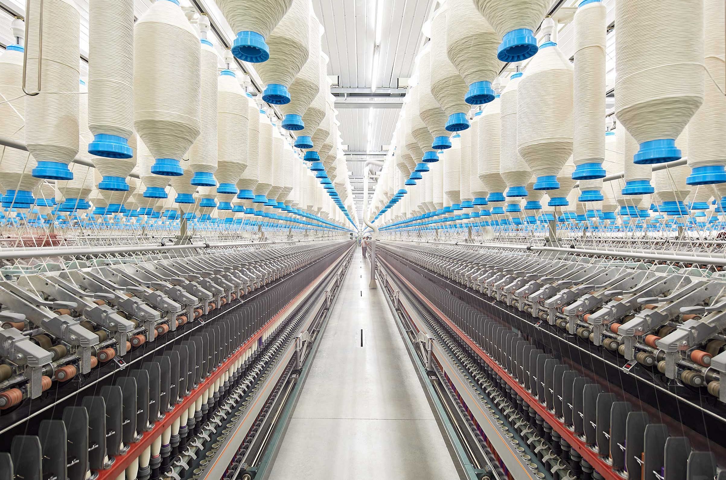 Two compact-spinning machines side by side in a spinning mill