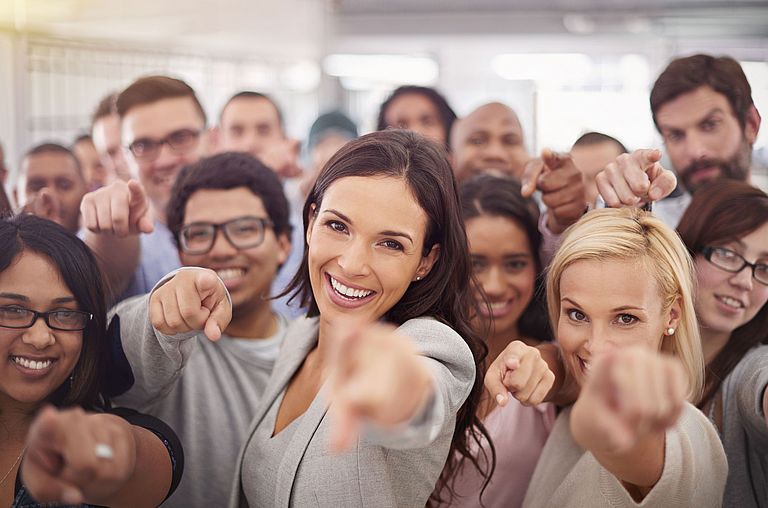 Group of employees pointing at you